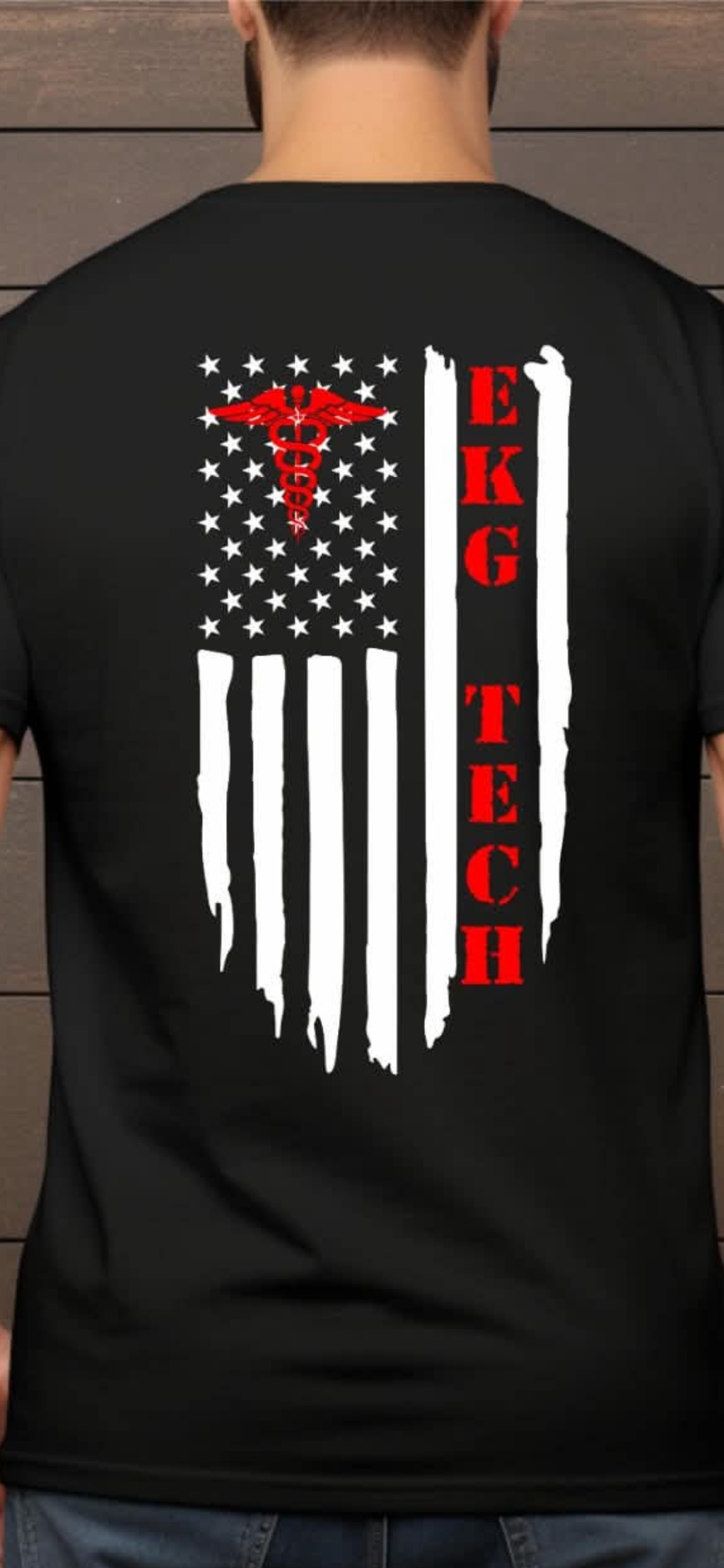 A man viewed from behind wearing a black t-shirt with a distressed American flag graphic on the back. The flag features white stars, white vertical stripes, a red caduceus symbol, and the text 'EKG TECH' in red.